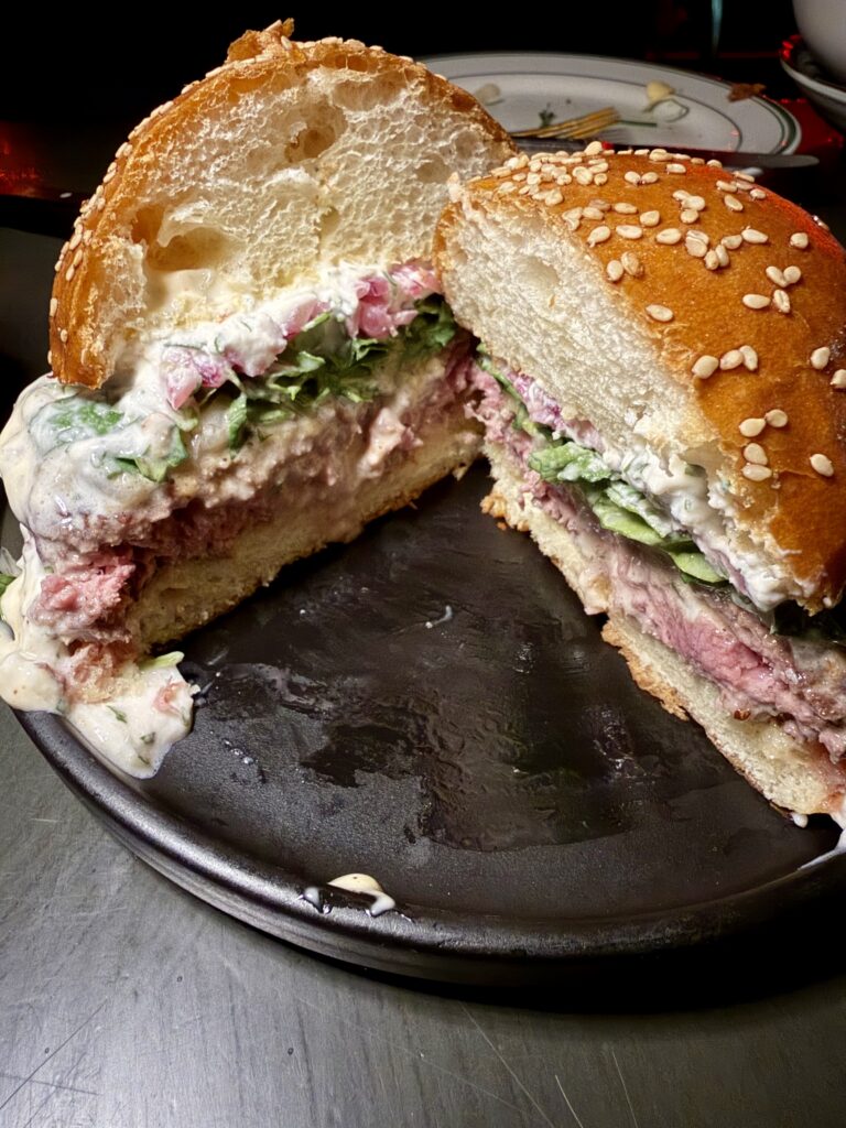 Cross-section of the New G/OG Burger at OyBar showing the char and doneness