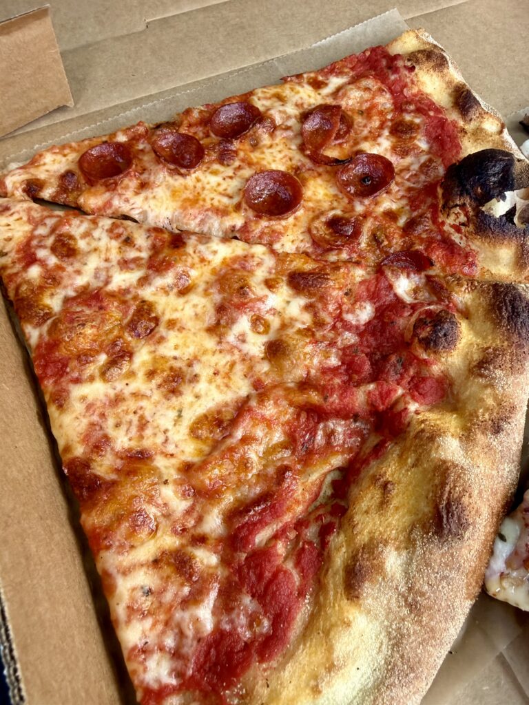 Thin-crust pepperoni slice and thin-crust cheese slice in a box